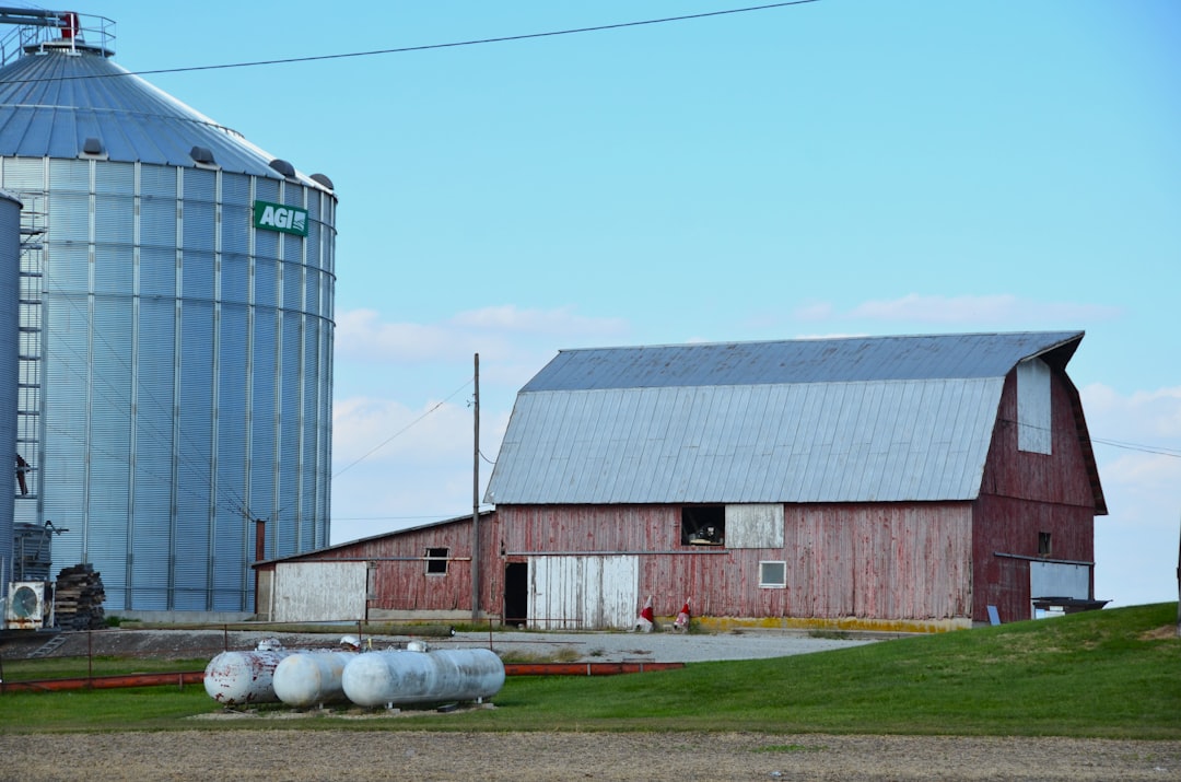 red-barn-and-grain-silo-on-a-sunny-day-2jwwyhhfjx0